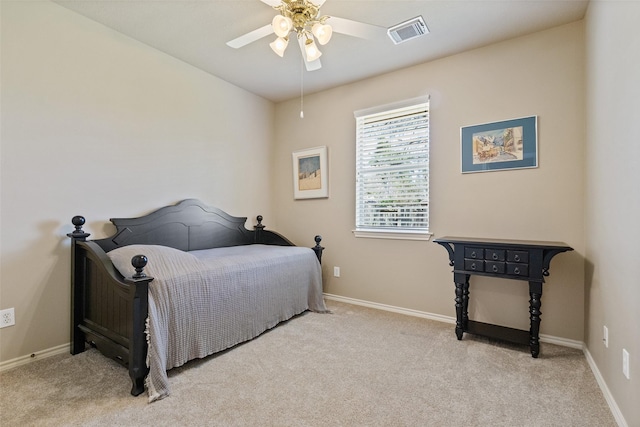 carpeted bedroom with a ceiling fan, baseboards, and visible vents