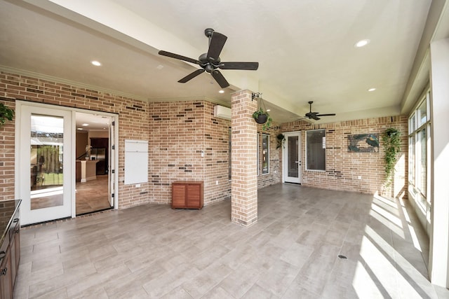 view of patio featuring an AC wall unit and a ceiling fan