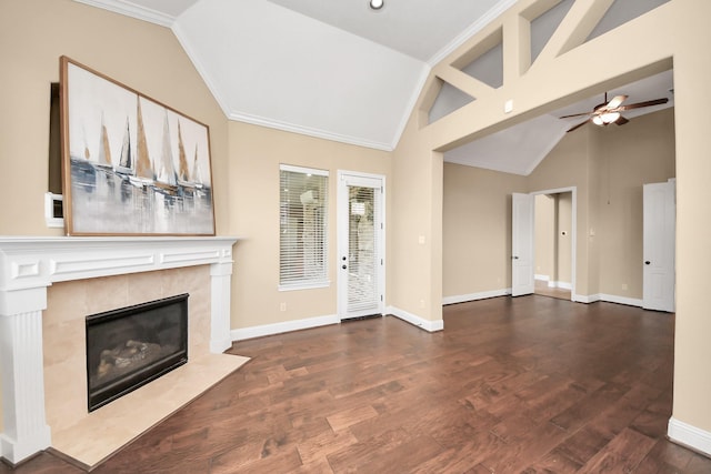 unfurnished living room with lofted ceiling, wood finished floors, baseboards, and a high end fireplace