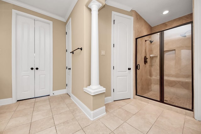 bathroom featuring decorative columns, baseboards, and a stall shower