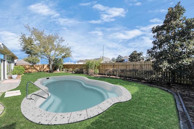 view of pool featuring a lawn and a fenced backyard