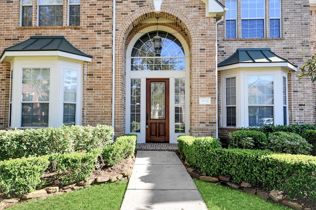 doorway to property with brick siding