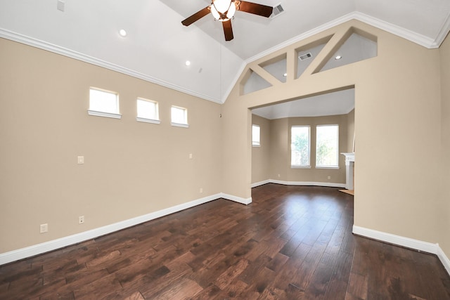 spare room with visible vents, dark wood-type flooring, crown molding, lofted ceiling, and a ceiling fan