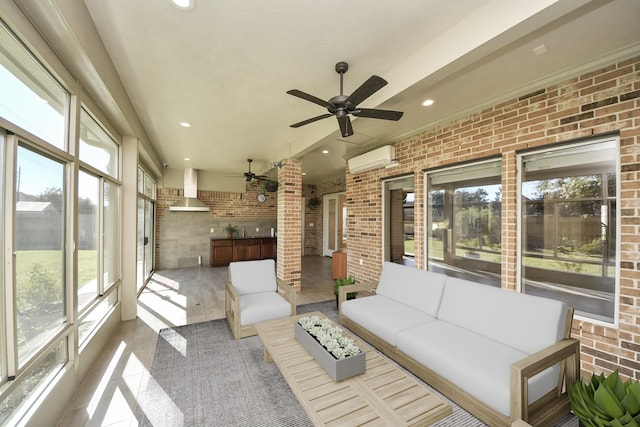 sunroom featuring an AC wall unit, a ceiling fan, and a sink