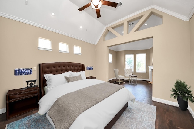 bedroom featuring visible vents, wood finished floors, crown molding, baseboards, and vaulted ceiling