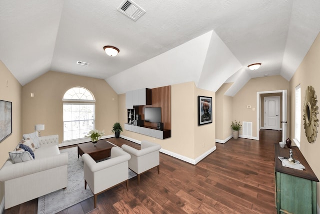 living area with visible vents, lofted ceiling, and dark wood finished floors