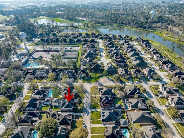 birds eye view of property with a water view and a residential view