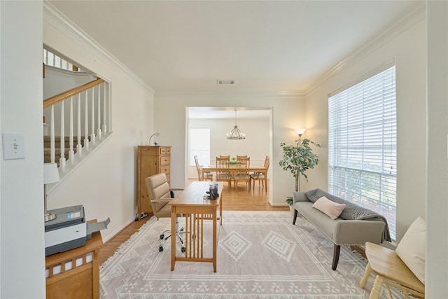 home office with visible vents, wood finished floors, a healthy amount of sunlight, and ornamental molding