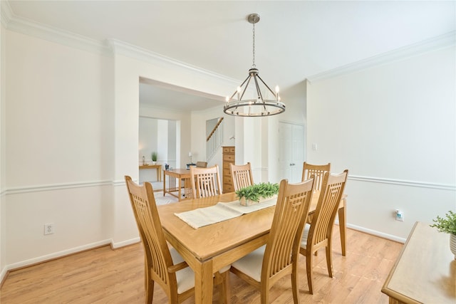 dining area featuring stairs, an inviting chandelier, crown molding, and light wood-type flooring