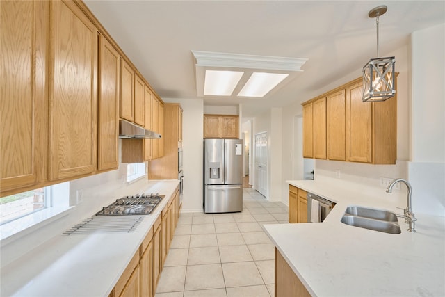 kitchen with light tile patterned floors, a sink, light countertops, under cabinet range hood, and appliances with stainless steel finishes