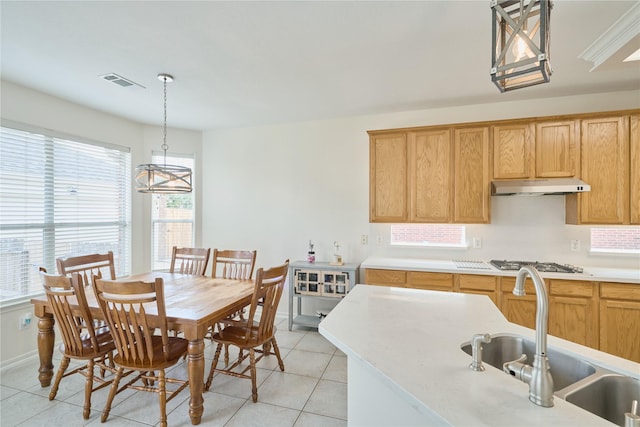 dining space featuring light tile patterned flooring, visible vents, and a chandelier