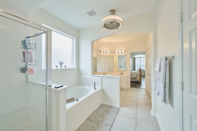 ensuite bathroom featuring tile patterned floors, visible vents, a garden tub, a stall shower, and connected bathroom