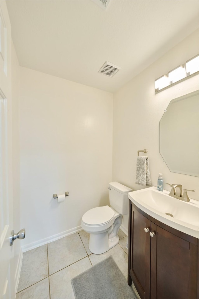 half bathroom featuring vanity, visible vents, baseboards, tile patterned flooring, and toilet