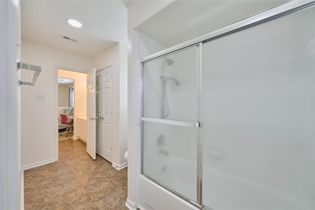 full bathroom featuring baseboards, visible vents, toilet, combined bath / shower with glass door, and connected bathroom