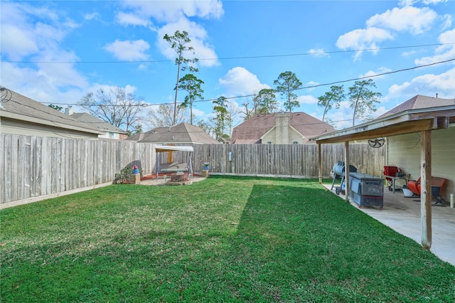 view of yard with a fenced backyard, an outdoor fire pit, and a patio