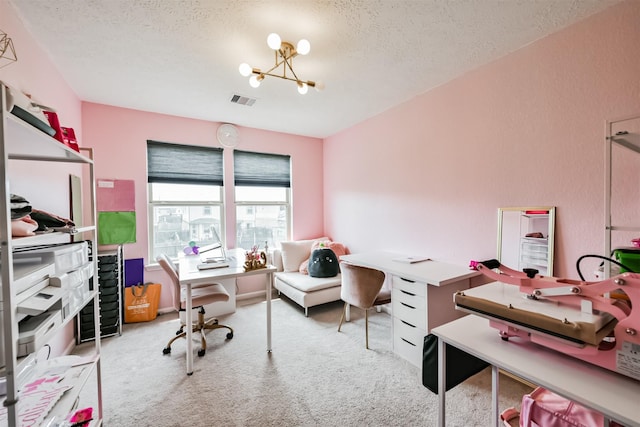 home office with a notable chandelier, visible vents, a textured ceiling, and carpet