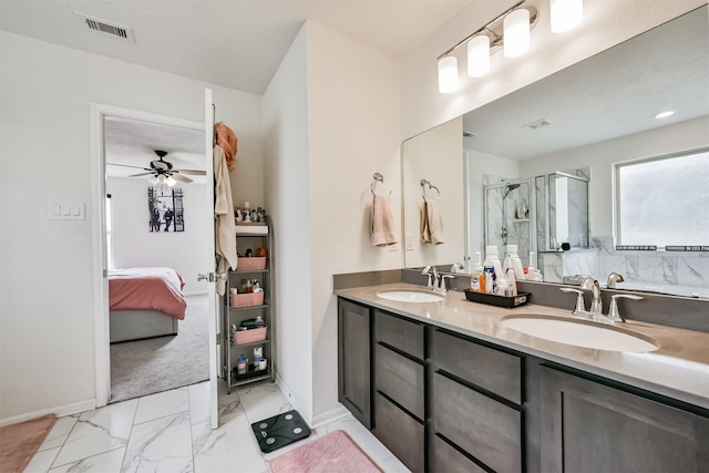 ensuite bathroom featuring a sink, visible vents, a stall shower, and ensuite bath