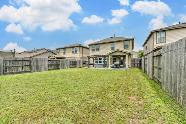 rear view of house with a yard, a patio area, and a fenced backyard