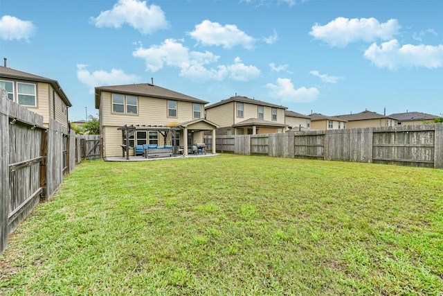 rear view of property with a yard, a patio, and a fenced backyard