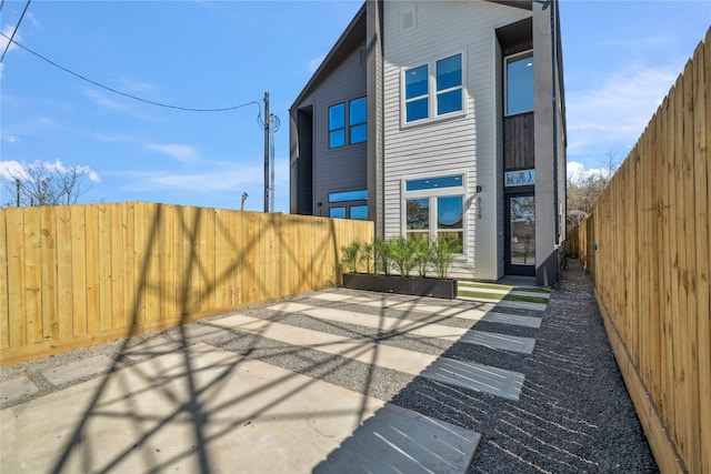 back of house featuring a fenced backyard