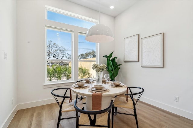 dining room featuring light wood-style flooring, recessed lighting, and baseboards