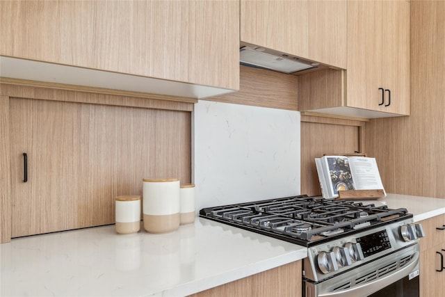 kitchen with light countertops, exhaust hood, stainless steel gas stove, and light brown cabinetry