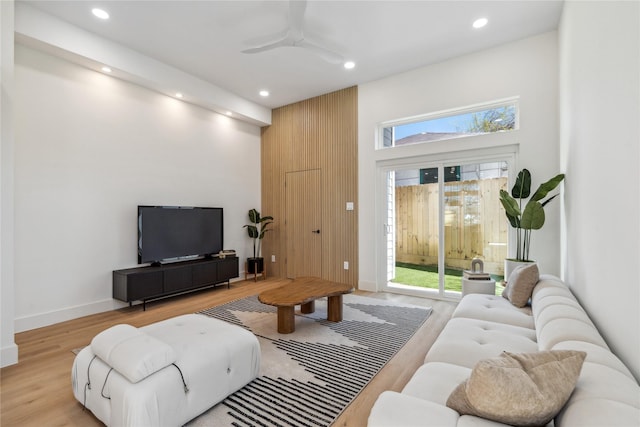 living room with recessed lighting, baseboards, light wood-type flooring, and a ceiling fan