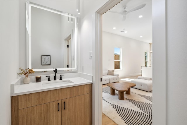 bathroom with recessed lighting, a ceiling fan, and vanity