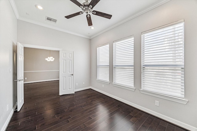 spare room featuring visible vents, ceiling fan with notable chandelier, crown molding, baseboards, and dark wood-style flooring