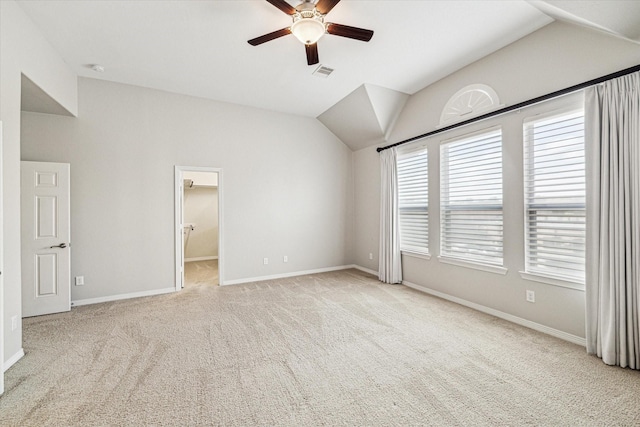 unfurnished bedroom featuring visible vents, carpet, and vaulted ceiling