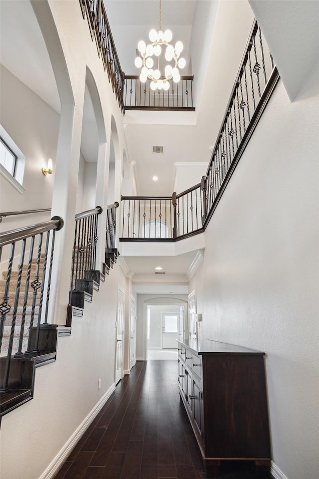 entryway with a high ceiling, dark wood-style floors, visible vents, and baseboards