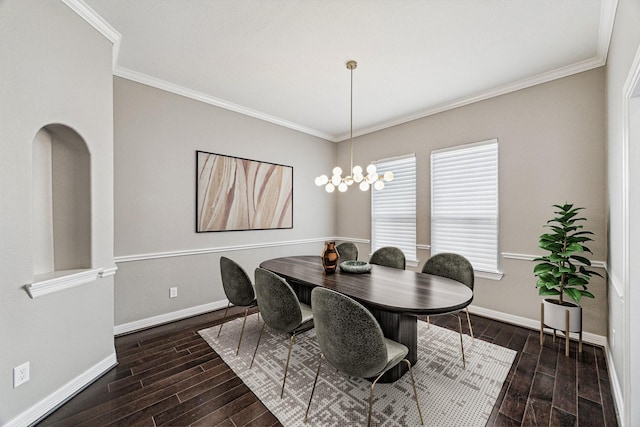 dining area featuring baseboards, crown molding, and wood finish floors