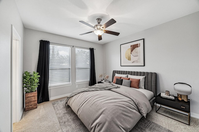 carpeted bedroom with a ceiling fan and baseboards