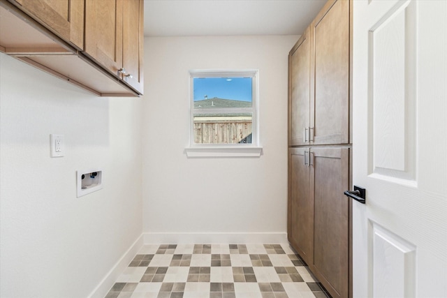 clothes washing area featuring hookup for a washing machine, cabinet space, baseboards, and light floors