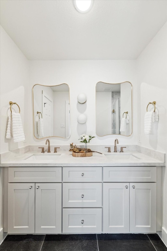 full bath with a sink and double vanity