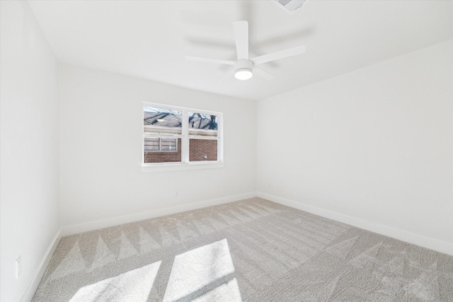 carpeted empty room featuring visible vents, baseboards, and ceiling fan