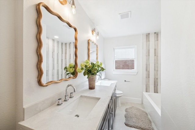 bathroom with visible vents, toilet, vanity, and baseboards