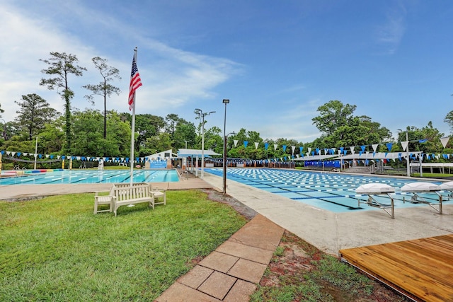 pool featuring a lawn and fence