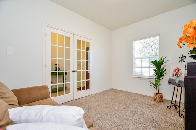 sitting room featuring carpet, french doors, and baseboards