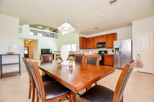 dining area with visible vents, a ceiling fan, recessed lighting, a high ceiling, and light tile patterned flooring