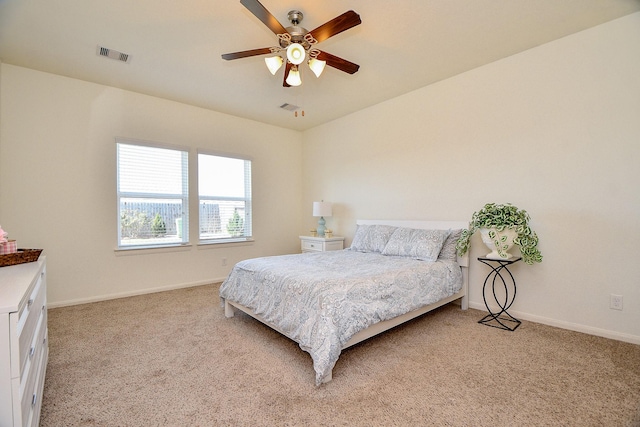 bedroom with ceiling fan, light colored carpet, visible vents, and baseboards