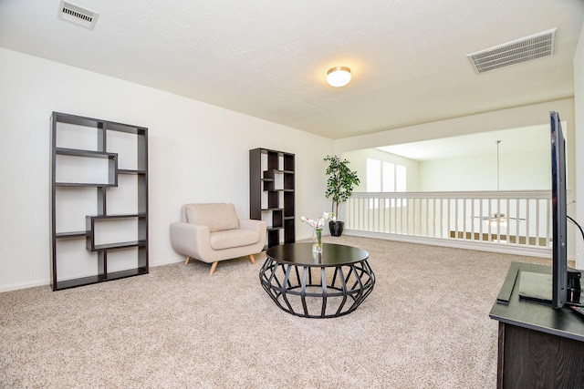 sitting room featuring visible vents, carpet floors, and baseboards