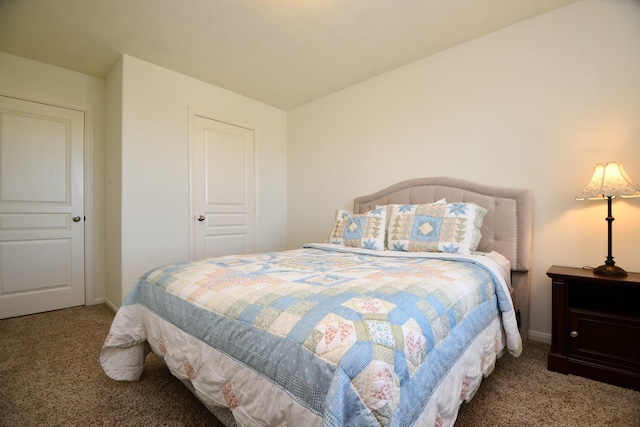 bedroom with baseboards and carpet floors