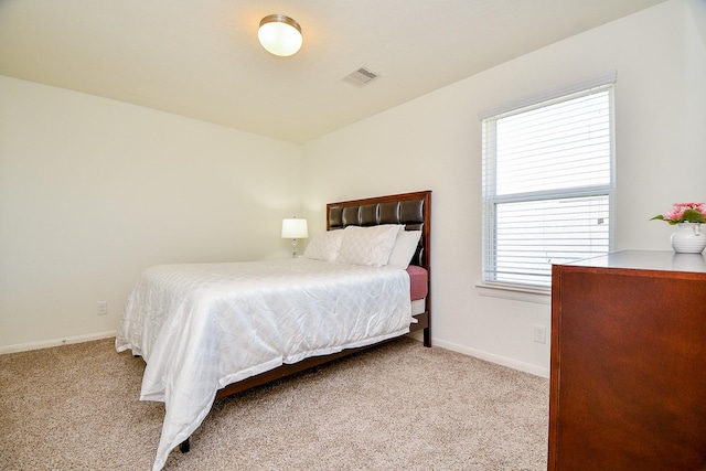 carpeted bedroom featuring visible vents and baseboards