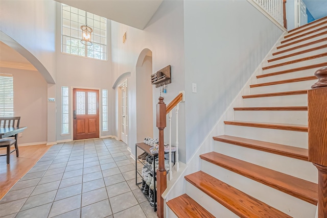 entrance foyer featuring stairway and a healthy amount of sunlight