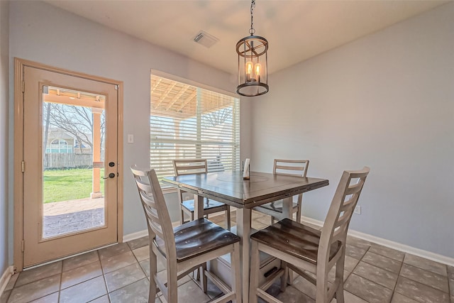 tiled dining room with visible vents and baseboards