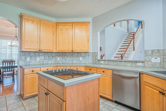 kitchen with stainless steel dishwasher and light brown cabinetry