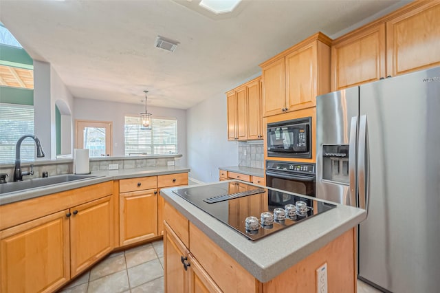 kitchen featuring tasteful backsplash, visible vents, light tile patterned floors, black appliances, and a sink