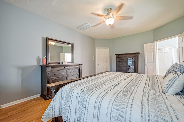 bedroom with visible vents, baseboards, light wood-style flooring, and a ceiling fan