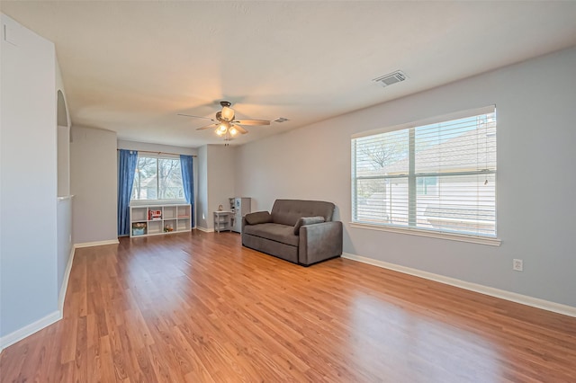 unfurnished room featuring visible vents, baseboards, ceiling fan, and light wood finished floors